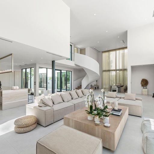 Double height living room with spiral staircase in a modern Miami home