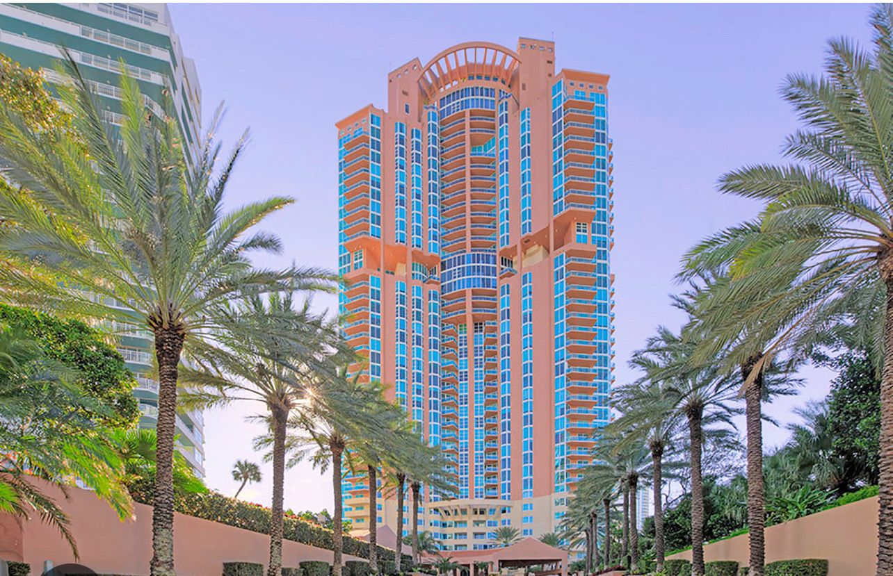 Palm lined approach to a South of Fifth condominium tower in Miami Beach